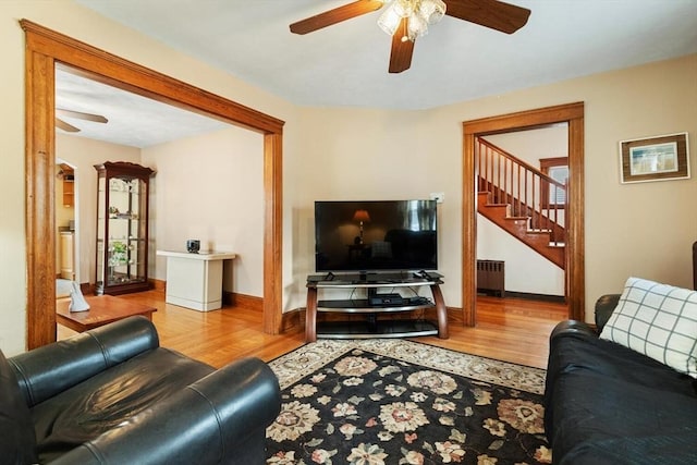 57 Taft St, Medford, MA 02155 - living area with a ceiling fan, radiator, wood finished floors, and stairs