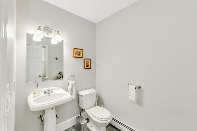half bathroom featuring toilet and baseboards