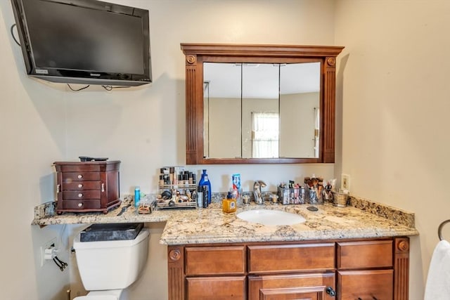bathroom featuring toilet and vanity