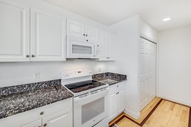 13 Laurel Hill Ct Unit 13, Bourne, MA 02532 - kitchen featuring white appliances, light wood-style flooring, white cabinets, dark stone countertops, and recessed lighting