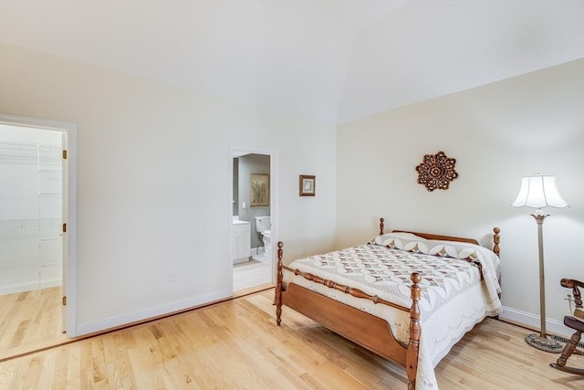 13 Laurel Hill Ct Unit 13, Bourne, MA 02532 - bedroom with wood finished floors, connected bathroom, and high vaulted ceiling