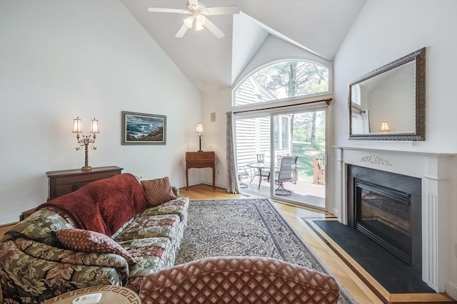 13 Laurel Hill Ct Unit 13, Bourne, MA 02532 - living room with wood finished floors, high vaulted ceiling, a ceiling fan, and a fireplace with flush hearth