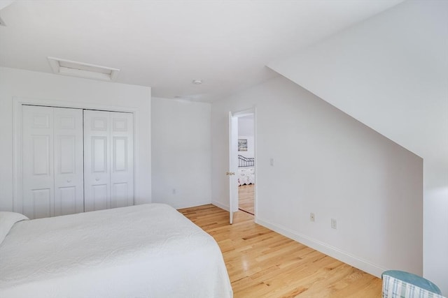 13 Laurel Hill Ct Unit 13, Bourne, MA 02532 - bedroom featuring light wood-type flooring, attic access, and a closet