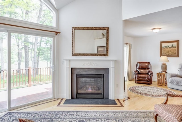 13 Laurel Hill Ct Unit 13, Bourne, MA 02532 - living room with wood finished floors, a fireplace with flush hearth, and high vaulted ceiling