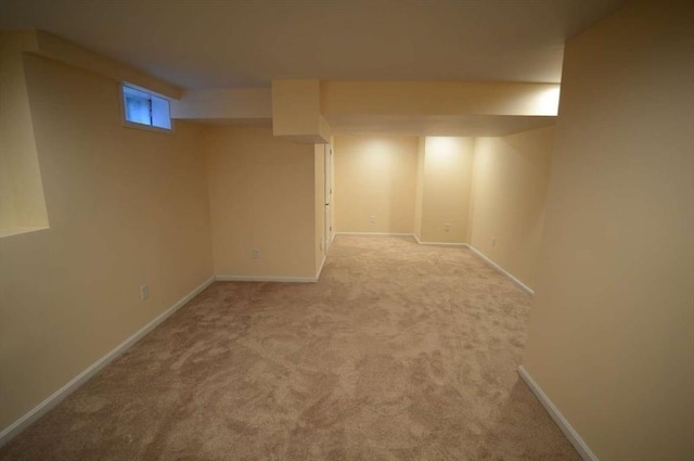 basement featuring light colored carpet