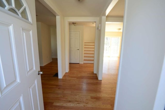 corridor with light hardwood / wood-style floors