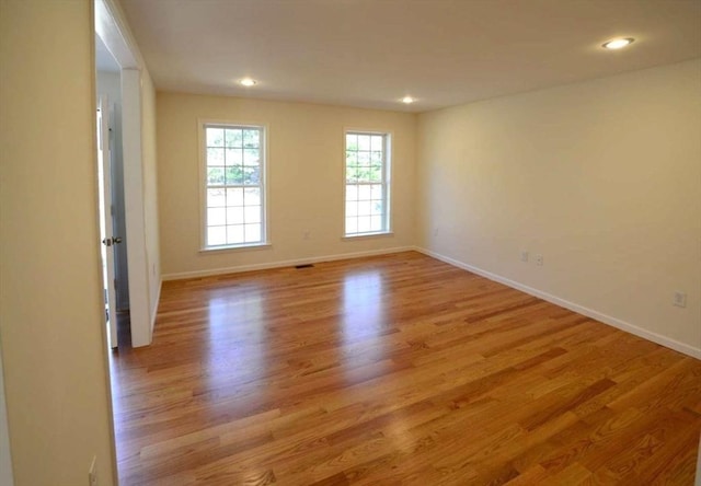 spare room with light hardwood / wood-style flooring