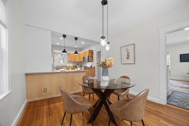 dining area featuring sink and light hardwood / wood-style flooring