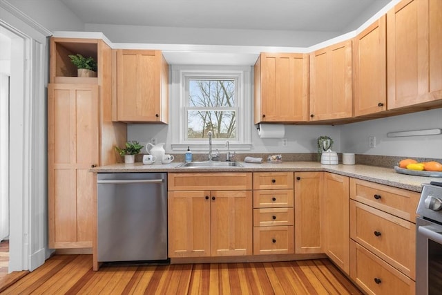 kitchen with stainless steel appliances, light brown cabinetry, sink, and light wood-type flooring