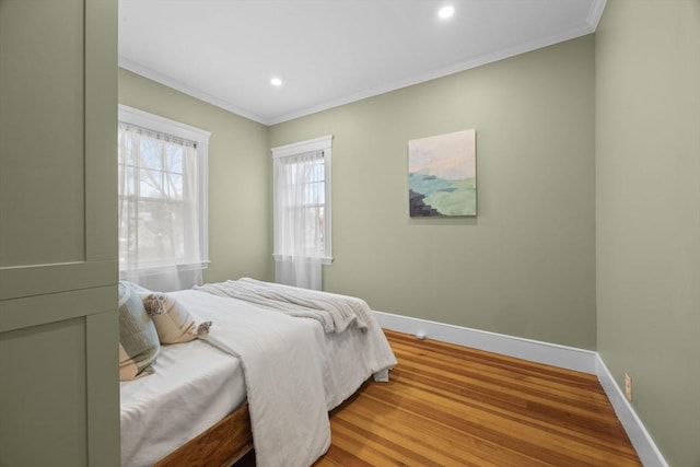 bedroom featuring hardwood / wood-style flooring and crown molding