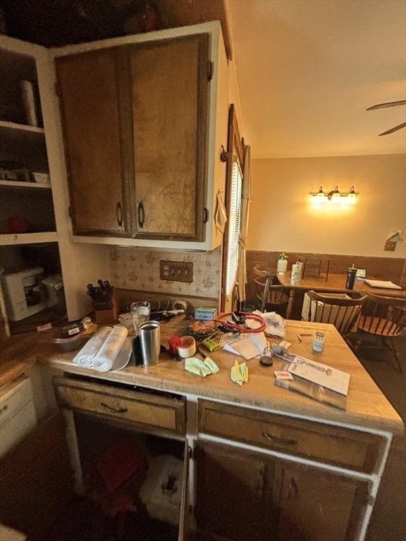 interior space with ceiling fan