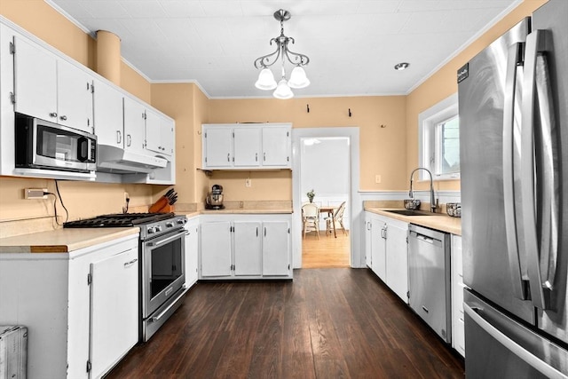 109 Bouve Ave, Brockton, MA 02301 - kitchen featuring stainless steel appliances, a sink, under cabinet range hood, dark wood-type flooring, and light countertops