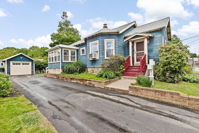 109 Bouve Ave, Brockton, MA 02301 - view of front facade featuring a garage, an outdoor structure, cooling unit, asphalt driveway, and a chimney