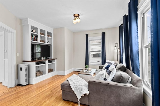 109 Bouve Ave, Brockton, MA 02301 - living area with wood finished floors, baseboards, and a baseboard heating unit