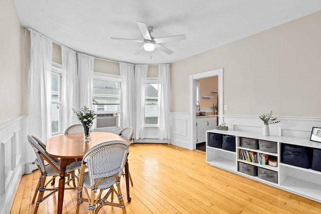 109 Bouve Ave, Brockton, MA 02301 - dining room with a wainscoted wall, a ceiling fan, light wood-style floors, cooling unit, and a decorative wall