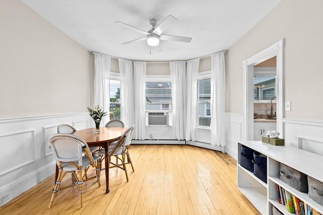 109 Bouve Ave, Brockton, MA 02301 - dining space with plenty of natural light, wainscoting, ceiling fan, and light wood-style flooring