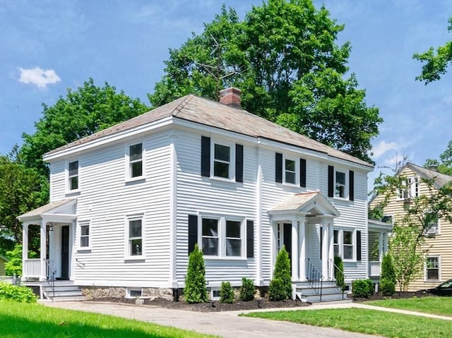 8 Carisbrooke St, Andover, MA 01810 - view of front of property with a chimney and a front yard
