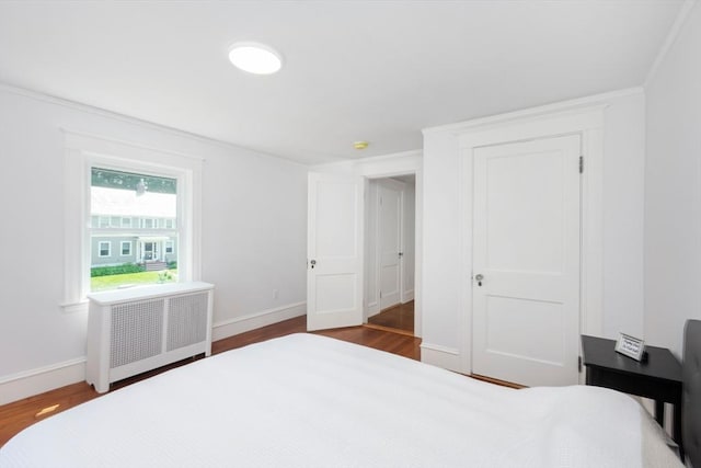 8 Carisbrooke St, Andover, MA 01810 - bedroom with radiator, wood finished floors, and crown molding