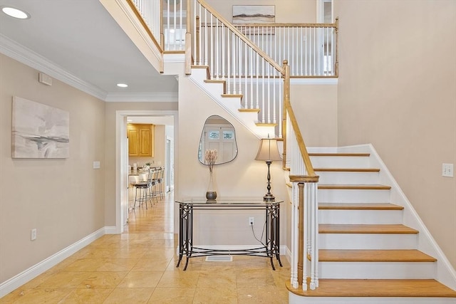 staircase with tile patterned flooring and crown molding