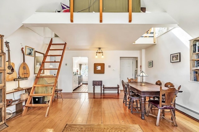 dining area featuring light wood-style floors and baseboard heating