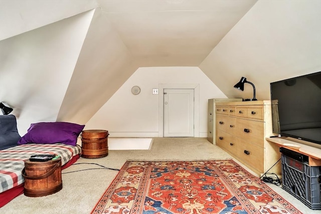 living area featuring light carpet and lofted ceiling