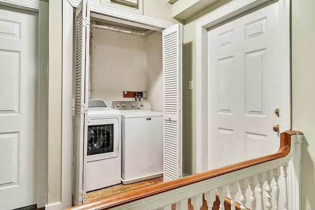 clothes washing area featuring laundry area and washer and clothes dryer