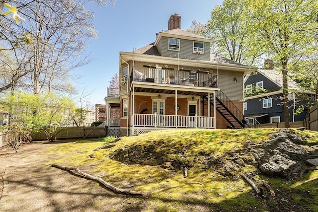 back of house with fence, a deck, french doors, a chimney, and stairs