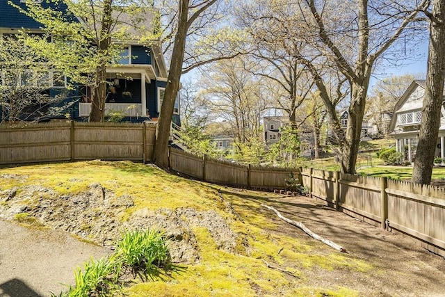 view of yard featuring a residential view and a fenced backyard