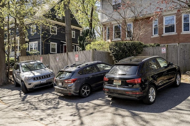 view of parking featuring fence