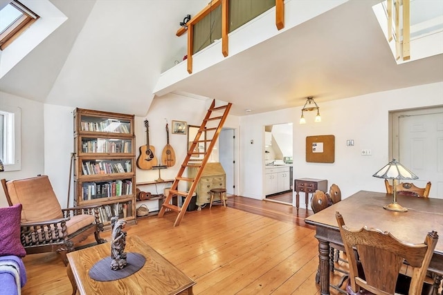 living room with vaulted ceiling and light wood-style flooring