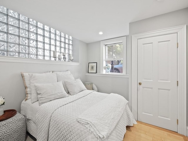 bedroom featuring recessed lighting and wood finished floors