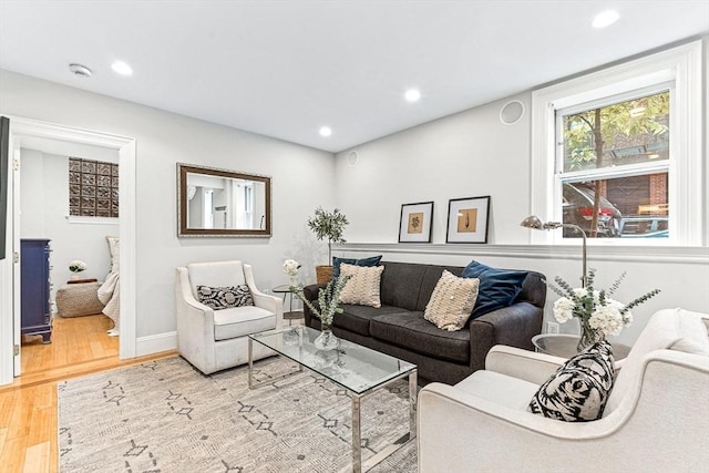 living area with recessed lighting, baseboards, and light wood-type flooring