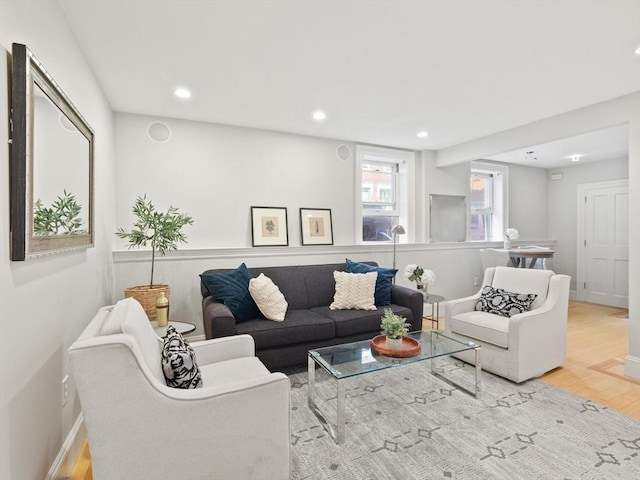 living area with recessed lighting, baseboards, and wood finished floors