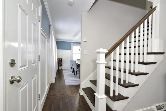 interior space featuring crown molding and dark hardwood / wood-style floors