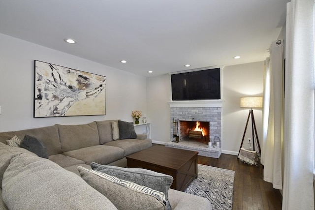 living room featuring dark hardwood / wood-style flooring and a fireplace