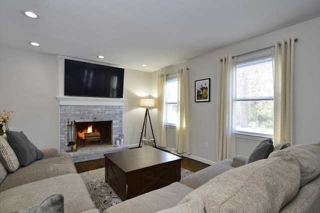 living room featuring hardwood / wood-style flooring and a fireplace