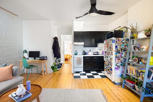 kitchen with ceiling fan, white appliances, and light hardwood / wood-style flooring