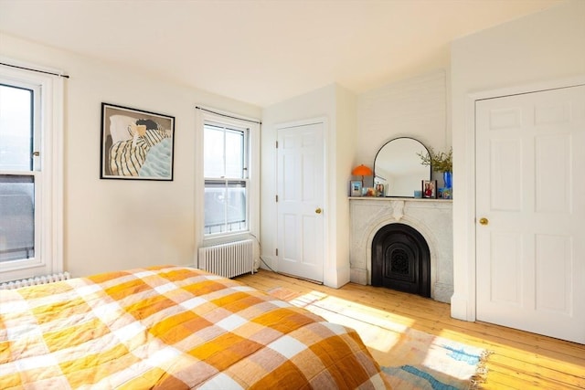 unfurnished bedroom with hardwood / wood-style flooring and radiator