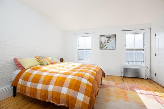 bedroom featuring radiator and light wood-type flooring