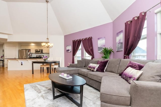 501 Commerce Dr Unit 1304, Braintree, MA 02184 - living area featuring high vaulted ceiling, a chandelier, healthy amount of natural light, and light wood finished floors