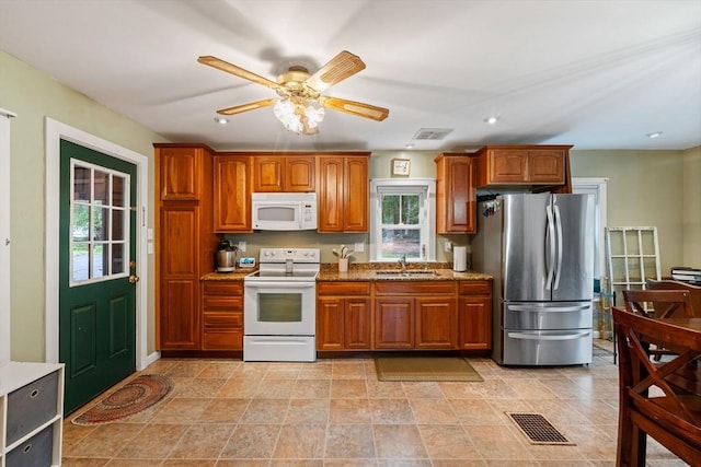 235 Union St, Northbridge, MA 01588 - kitchen featuring white appliances, brown cabinetry, light stone countertops, ceiling fan, and recessed lighting