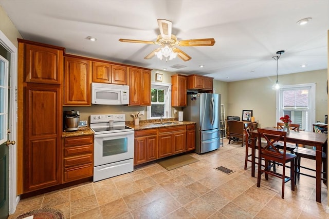 235 Union St, Northbridge, MA 01588 - kitchen featuring white appliances, brown cabinets, hanging light fixtures, a ceiling fan, and light stone counters