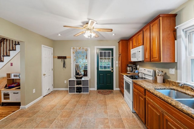 235 Union St, Northbridge, MA 01588 - kitchen featuring white appliances, brown cabinetry, a ceiling fan, light stone countertops, and plenty of natural light
