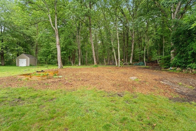 235 Union St, Northbridge, MA 01588 - view of grassy yard with a shed, a garden, and a wooded view