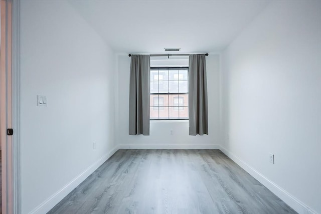 unfurnished room with hardwood / wood-style floors