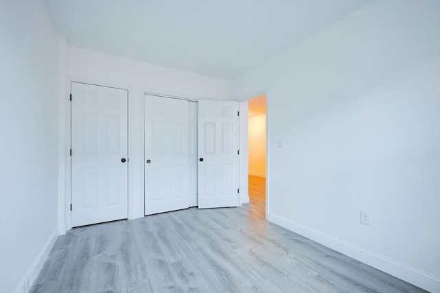 unfurnished bedroom featuring light wood-type flooring