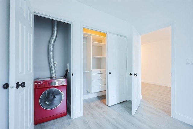 laundry room featuring light hardwood / wood-style flooring and washer / dryer