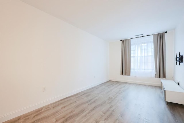 spare room featuring light wood-type flooring