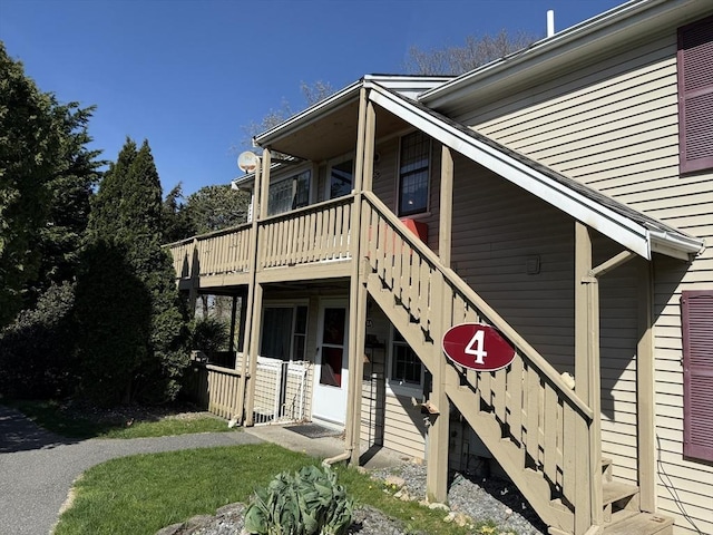 view of front of home with stairway and a wooden deck