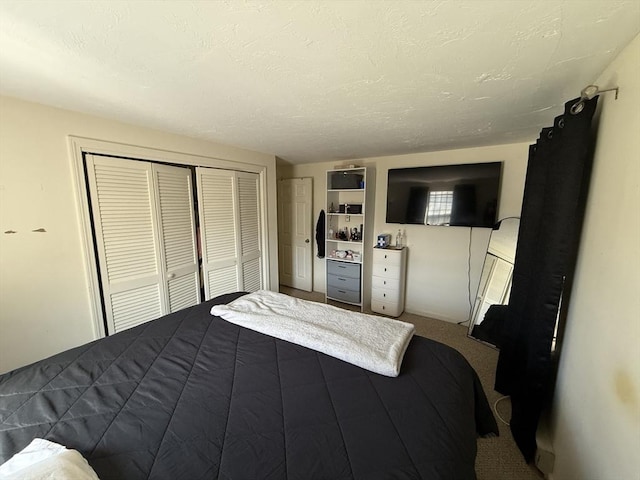 bedroom with a closet, dark carpet, and a textured ceiling